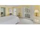 Airy bedroom with yellow walls, plantation shutters, and charming decor providing a comfortable retreat at 2 Antigua Cir # 4, Englewood, FL 34223