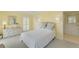 Comfortable bedroom features soft yellow walls, white furnishings, and tranquil decor for relaxation at 2 Antigua Cir # 4, Englewood, FL 34223