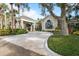 Charming clubhouse featuring a covered entrance, elegant architecture, and lush landscaping at 2 Antigua Cir # 4, Englewood, FL 34223