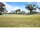 Scenic golf course featuring manicured greens and mature trees in a well-maintained community at 2 Antigua Cir # 4, Englewood, FL 34223