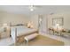 Inviting main bedroom with decorative lamps, neutral tones, and a seamless flow into adjacent rooms at 2 Antigua Cir # 4, Englewood, FL 34223