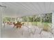 Enclosed sunroom with tile floor, walls of windows, and multiple seating areas at 2 Antigua Cir # 4, Englewood, FL 34223