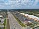 Aerial view of a retail shopping center with a busy highway nearby, surrounded by businesses and traffic at 2 Hungary Rd, North Port, FL 34288
