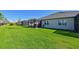 Expansive backyard with lush green grass and a view of the screened-in patio at 209 Okeeffe Cir, Bradenton, FL 34212