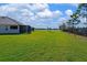 Expansive backyard with a serene lake view, ideal for relaxation and outdoor enjoyment at 209 Okeeffe Cir, Bradenton, FL 34212
