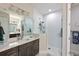 Modern bathroom with a glass-enclosed shower, a vanity with double sinks and white subway tile at 209 Okeeffe Cir, Bradenton, FL 34212