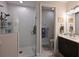 Modern bathroom featuring glass-enclosed shower, double sink vanity, and well lit commode area at 209 Okeeffe Cir, Bradenton, FL 34212