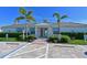 Exterior shot of the Watercolor Place Clubhouse, a welcoming entrance with manicured landscaping at 209 Okeeffe Cir, Bradenton, FL 34212