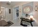 Inviting entryway with stylish console table, decorative mirror, and tile flooring at 209 Okeeffe Cir, Bradenton, FL 34212