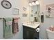 Charming half bath features a modern vanity, decorative accents, and ample lighting at 209 Okeeffe Cir, Bradenton, FL 34212