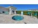 Community hot tub is surrounded by lush landscaping and comfortable lounge seating for residents at 209 Okeeffe Cir, Bradenton, FL 34212
