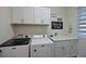 Well-equipped laundry room with modern washer, dryer, sink and sleek white cabinetry at 209 Okeeffe Cir, Bradenton, FL 34212