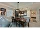 Open-concept living and dining area with tile floors, modern light fixture, and kitchen access at 209 Okeeffe Cir, Bradenton, FL 34212