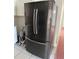 A refrigerator with black exterior and stainless steel handles in the kitchen at 216 Amherst Ave # 97, Sarasota, FL 34232