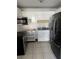 Functional kitchen with ample white cabinetry, stainless steel appliances, and tile floors at 216 Amherst Ave # 97, Sarasota, FL 34232