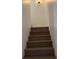 Staircase with solid surface treads and white trim, ascending to the upper level at 216 Amherst Ave # 97, Sarasota, FL 34232