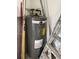 Classic Rheem water heater in a storage area with ladder and tools at 216 Amherst Ave # 97, Sarasota, FL 34232