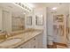 Bathroom featuring double sinks, granite countertops, and glass-enclosed shower, offering style and functionality at 2320 Terra Ceia Bay Blvd # 808, Palmetto, FL 34221