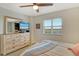 Cozy bedroom with a ceiling fan, TV, dresser and serene views from the window at 2320 Terra Ceia Bay Blvd # 808, Palmetto, FL 34221