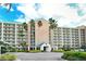 Grand condo building entrance with palm trees, covered drop off, and ample parking at 2320 Terra Ceia Bay Blvd # 808, Palmetto, FL 34221