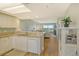 Open-concept kitchen with granite counters, white cabinets, stainless steel appliances, and a seamless flow to the living area at 2320 Terra Ceia Bay Blvd # 808, Palmetto, FL 34221