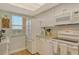 Bright kitchen features granite countertops, white cabinetry, modern appliances and a view from the window at 2320 Terra Ceia Bay Blvd # 808, Palmetto, FL 34221