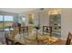Cozy living room boasts a glass table, built-in shelving, and a scenic balcony view at 2320 Terra Ceia Bay Blvd # 808, Palmetto, FL 34221