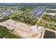 Aerial view of the expansive land parcel surrounded by construction, green space, and community homes at 2900 Curry Ln, Nokomis, FL 34275