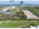 Aerial view of the property surrounded by lush landscapes, golf course, and nearby amenities at 2900 Curry Ln, Nokomis, FL 34275