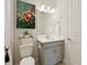 Stylish bathroom with modern vanity, contemporary lighting, and elegant floral artwork at 3008 Tolmino Ct, Lakewood Ranch, FL 34211