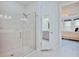 Modern bathroom showcasing a tiled shower with glass door and access to the bedroom at 3008 Tolmino Ct, Lakewood Ranch, FL 34211
