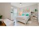 Inviting bedroom with soft turquoise accents, plush bedding, and decorative shelving at 3008 Tolmino Ct, Lakewood Ranch, FL 34211