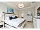 Comfortable bedroom with an elegant bed, light colored walls, and a door leading to the Primary bathroom at 3008 Tolmino Ct, Lakewood Ranch, FL 34211