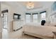 Bright bedroom featuring a neutral color palette, a comfortable bed, and ample natural light from the windows at 3008 Tolmino Ct, Lakewood Ranch, FL 34211