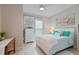 Comfortable bedroom with turquoise accents, plush bedding, and decorative floral artwork at 3008 Tolmino Ct, Lakewood Ranch, FL 34211