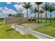 Elegant stone community entrance sign with lush landscaping, setting a welcoming tone for the neighborhood at 3008 Tolmino Ct, Lakewood Ranch, FL 34211