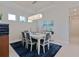 Dining room with a blue accent rug and eye-catching light fixture above the table at 3008 Tolmino Ct, Lakewood Ranch, FL 34211