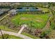 Aerial view of the community's fenced dog park, featuring grassy areas and convenient seating for residents at 3008 Tolmino Ct, Lakewood Ranch, FL 34211