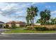 Well-maintained house with a tile roof, a two-car garage and neatly landscaped front yard at 3008 Tolmino Ct, Lakewood Ranch, FL 34211