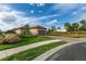 Exterior view of the house with a paved driveway and well-maintained landscaping under a bright sky at 3008 Tolmino Ct, Lakewood Ranch, FL 34211
