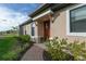 Charming front entrance with a brick walkway, well-manicured landscaping, and a red front door at 3008 Tolmino Ct, Lakewood Ranch, FL 34211