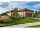 Charming single-story home featuring a well-maintained lawn and a clay tile roof on a sunny day at 3008 Tolmino Ct, Lakewood Ranch, FL 34211