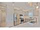 Modern kitchen with stainless steel appliances, elegant gray cabinetry, and stylish pendant lighting at 3008 Tolmino Ct, Lakewood Ranch, FL 34211