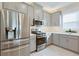 Modern kitchen features stainless steel appliances, sleek gray cabinetry, and bright countertops at 3008 Tolmino Ct, Lakewood Ranch, FL 34211