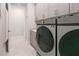 Well-organized laundry room with modern cabinets, countertop, and a washer/dryer at 3008 Tolmino Ct, Lakewood Ranch, FL 34211