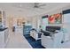 Open-concept living room with modern furnishings, a bright painting, and tile flooring at 3008 Tolmino Ct, Lakewood Ranch, FL 34211