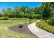 Community park with walking path, benches, and lush green spaces at 3008 Tolmino Ct, Lakewood Ranch, FL 34211