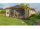 Charming home featuring a screened-in lanai, perfect for enjoying the outdoors, with a mature palm tree in the backyard at 3008 Tolmino Ct, Lakewood Ranch, FL 34211