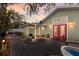 Backyard patio with a hot tub, outdoor seating, string lights, and a privacy fence at 3521 Almeria Ave, Sarasota, FL 34239