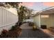 Backyard patio with an outdoor dining set, BBQ grill, and ambient string lights at 3521 Almeria Ave, Sarasota, FL 34239